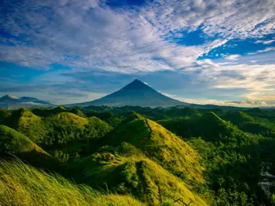 Beautiful landscape of Mayon Volcano amidst verdant hills in Bicol, Philippines.