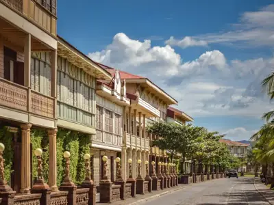 a street lined with wooden buildings and palm trees
