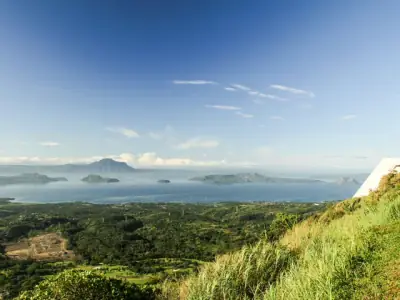 Stunning landscape of Taal Volcano and Taal Lake from Talisay, Philippines captured on a sunny day.