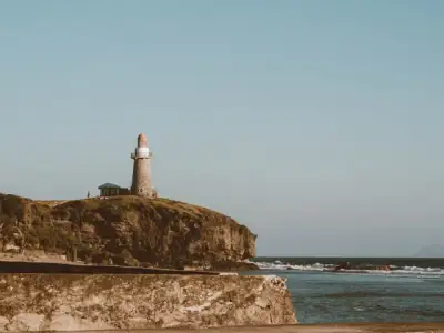 Scenic seaside view of a lighthouse on a cliff in Cagayan Valley, Philippines.