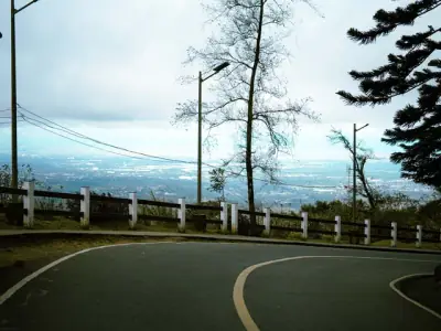 A serene view of a winding road overlooking Tagaytay City's vast landscape in the Philippines.