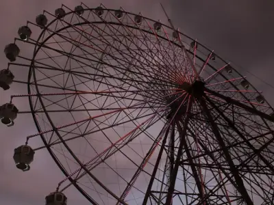 A captivating view of an illuminated Ferris wheel in Tagaytay against a dramatic evening sky.