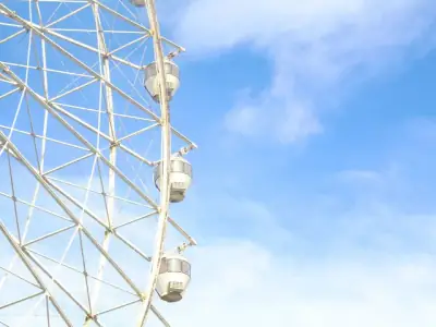 A striking image of a Ferris wheel against a bright blue sky in Tagaytay, Philippines.