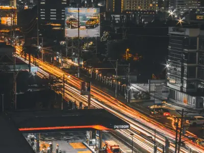 A dynamic long-exposure shot of Cebu City at night, highlighting the bustling urban life with illuminated streets and buildings.