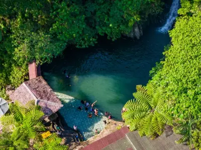 Stunning aerial view of a tropical resort pool and waterfall in Cebu City, Philippines.