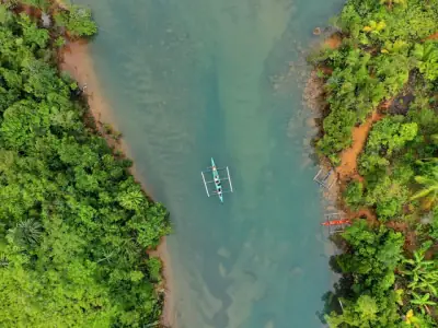 Stunning aerial shot of a tropical river with native boats in Guiuan, Philippines.