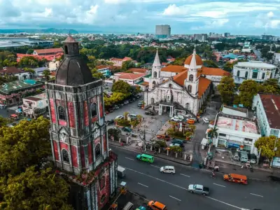 Stunning drone shot capturing Jaro Cathedral and surrounding urban landscape in Iloilo City, Philippines.