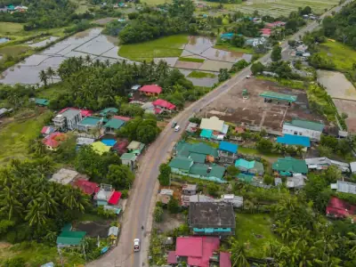 Aerial photo of a rural village in Gonzaga, Cagayan Valley, showcasing lush greenery and rice fields.