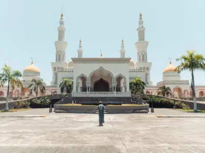 Front view of the Grand Mosque of Cotabato with mesmerizing minarets and palm trees.