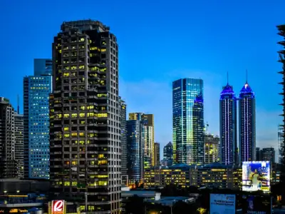 Illuminated skyscrapers at night in Pasig City, Philippines, showcasing modern architecture.