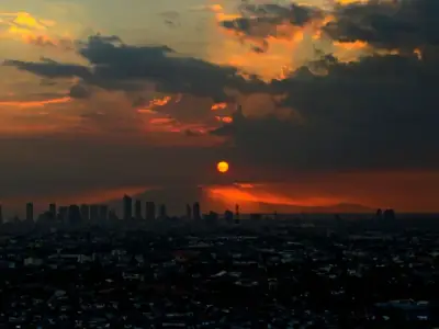 Captivating view of Manila skyline under dramatic sunset clouds.