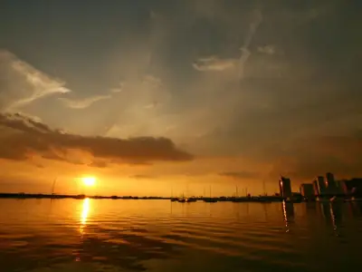 Breathtaking sunset over Manila Bay with a stunning city skyline silhouette reflecting on tranquil waters.