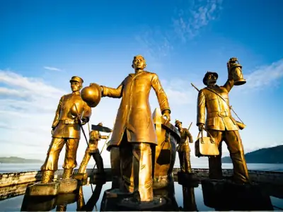 Golden statues at Rizal Landing Monument in sunny Zamboanga del Norte, Philippines.