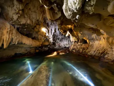 Explore a magnificent cave featuring unique rock formations and a serene underground river.
