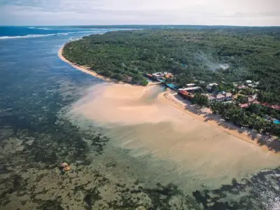 A stunning aerial shot of Patar Beach's golden sands and clear waters in Bolinao, Ilocos Region, Philippines.