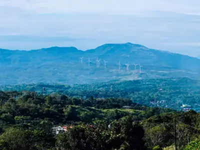 Scenic view of wind turbines on lush mountains in Antipolo, Calabarzon, Philippines.