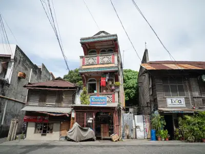 Charming old wooden buildings on a street in Dumaguete City, showcasing traditional architecture.