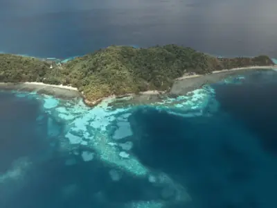 A stunning aerial view of a tropical island surrounded by the vibrant Sulu Sea in the Philippines.